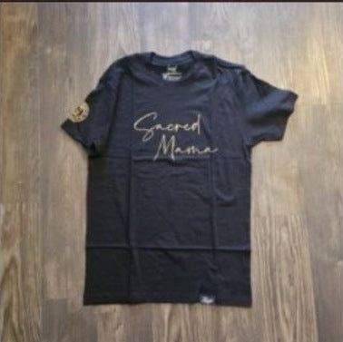 Sacred Mama Tee | Black & Gold photographed on wood floor