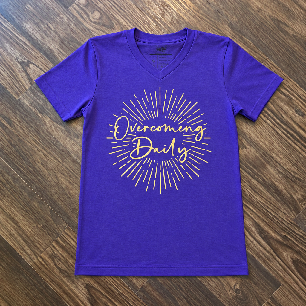 Purple Overcoming Daily V-neck shirt with gold sunburst design